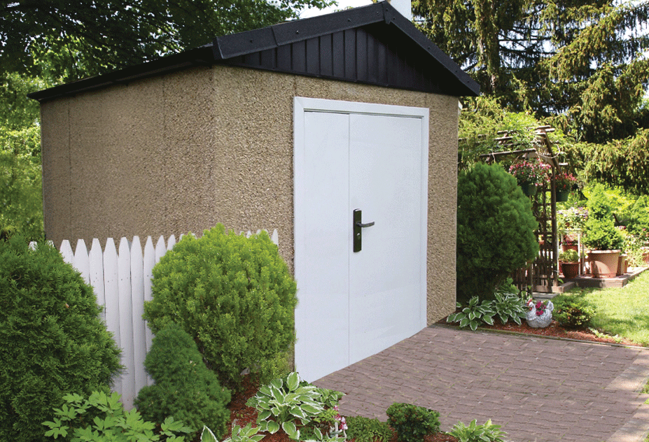 The Norton Shed in a beautiful garden with white fence on left